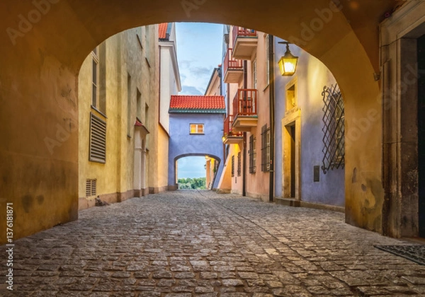 Fototapeta Warsaw Old Town. HDR view of narrow street with arch gate at dusk