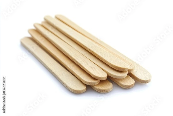 Fototapeta Wooden popsicle sticks.  Stacked, light brown wooden sticks, close-up against white background.  Ideal for ice cream, frozen treats, and other DIY projects
