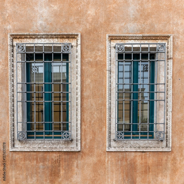 Obraz Two windows on an orange ocher colored wall of a vintage building. Space for your text and logo.