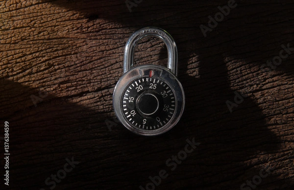 Fototapeta Combination padlock and master key with shadow on wood background