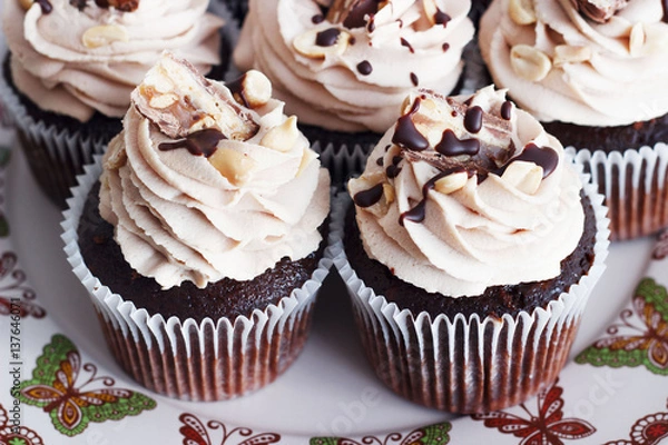 Obraz Chocolate cupcake with mousse cream icing on grunge white wooden background copy space