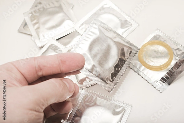 Obraz An open condom in a package. Male contraceptives. The condom is in your hand.