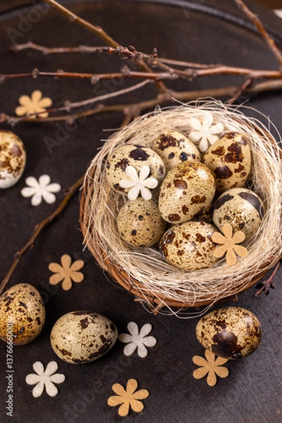 Fototapeta Quail eggs nest with spring decorations symbolizing new life