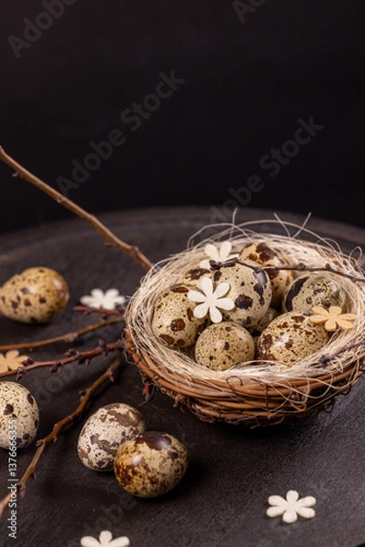 Fototapeta Quail eggs nest with spring decorations symbolizing new life
