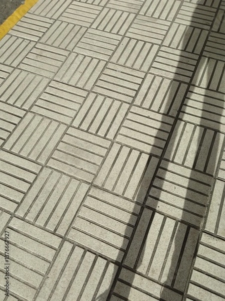 Fototapeta outdoor tile floor texture with person shadow
