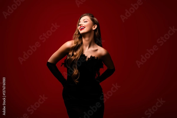 Fototapeta Photo of happy smiling touch black glamour gown posing enjoying isolated red color background
