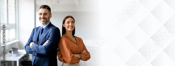 Fototapeta Successful happy businessman and businesswoman standing back to back with arms crossed and smiling at camera, office interior. Partnership concept, copy space