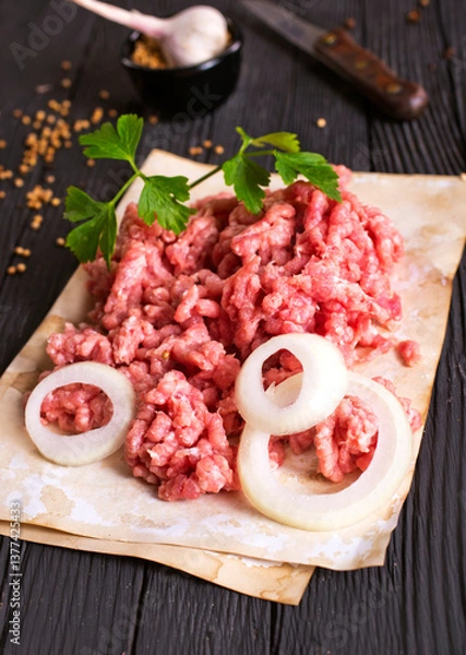 Fototapeta Raw minced pork. Black background. Top view. Space for text