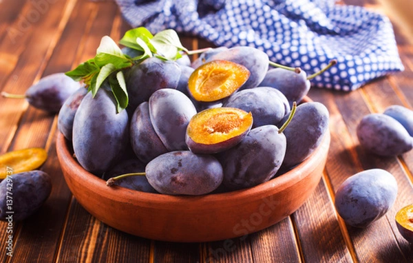 Obraz Fresh plums on plate over dark wooden background