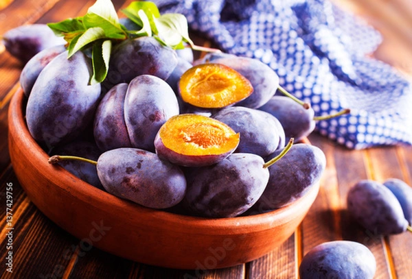 Obraz Fresh plums on plate over dark wooden background