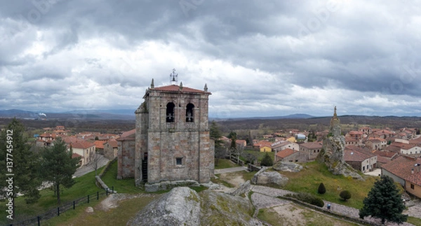 Fototapeta Charming Village with Ancient Stone Tower and Clouds