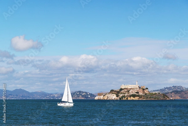 Fototapeta Scenic San Francisco landscape with Alcatraz Island and a yacht sailing in the bay