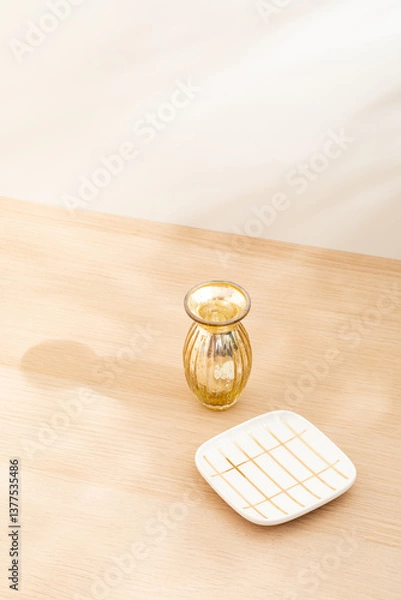 Obraz Copy space warm lighting background.Blank wallpaper with minimalist vase.Light and Shadow. Space for text.Backdrop.Studio photography.Sunshine. Chic style. Vase isolated on wooden. Home decor. Clean.