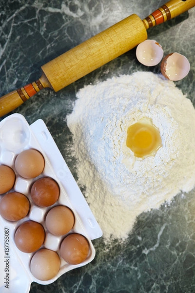Fototapeta different ingredients for preparing flour products on kitchen table