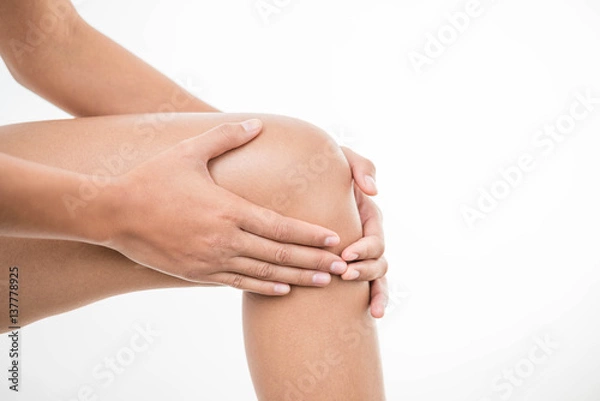 Fototapeta Tendon knee joint problems closeup cropped image woman leg isolated on  white background. Joint trauma concept