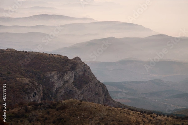 Obraz Panoramic view to the mountain ridge at the seaside of Black sea. Layer of mountains and mist at sunrise time, Crimea, Russia