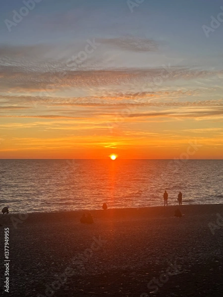 Fototapeta Red sun setting over the sea