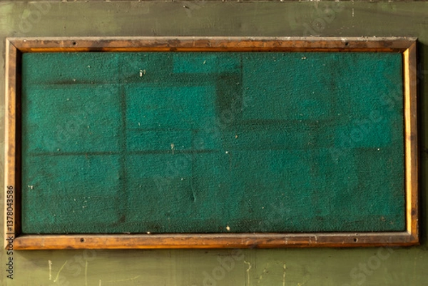 Obraz A detailed shot of the textured green surface of an old notice board. The image focuses on the worn and aged fabric, highlighting its vintage character.