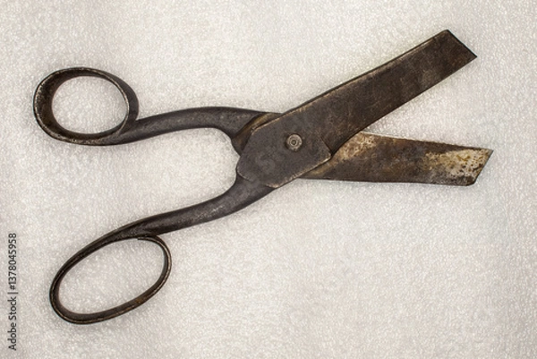 Fototapeta Vintage (late 19th century) forged steel tailor's scissors with traces of rust. On a white background.