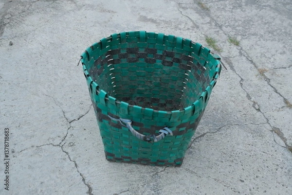 Fototapeta photo of a green trash can on the ground