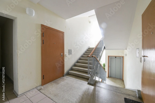 Fototapeta Apartment building hallway with stairs and elevator. Light, clean, and modern interior design.