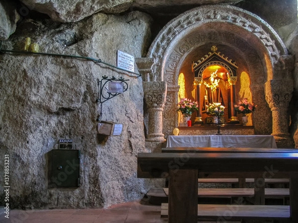 Fototapeta Guimaraes, Portugal. Our Lady of Lourdes Cave with Our Lady statue in altar. 19th Century Catholic Marian shrine in Penha Mount.