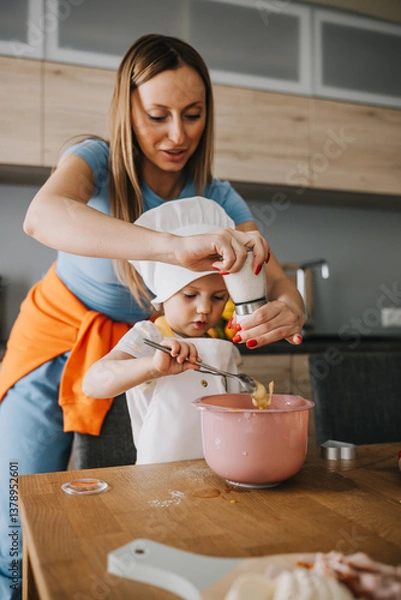 Obraz Daughter and mother making pizza together for dinner at the kitchen