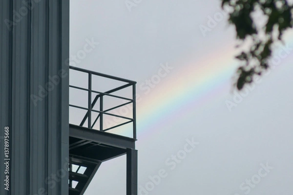 Fototapeta Rainbow Against Industrial Structure with Staircase