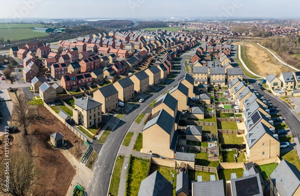 Fototapeta Aerial view of a new build housing estate with characterless houses in a row
