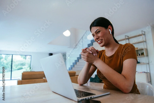 Fototapeta Woman sitting in living room using laptop looking at cam talk by video call with business friend relatives, head shot. Job interview answering questions