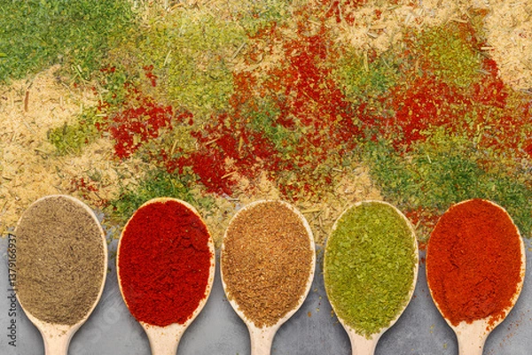 Obraz Spices turmeric and paprika in spoons and scattered. Top view.