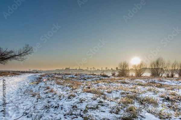 Obraz sunset over snowy warsaw