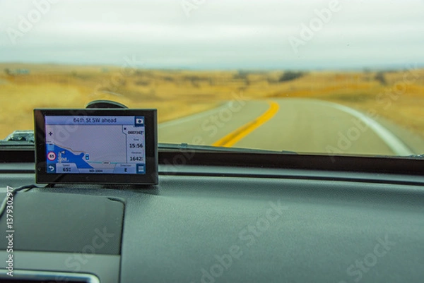 Obraz GPS unit mounted to vehicle windshield showing the road ahead, background out of focus.