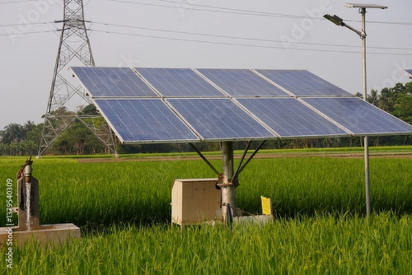 Obraz A solar-powered water pump installed in a field