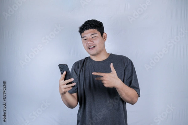 Obraz Man experiencing a headache, stressed expression. Studio shot of a man with a distressed expression, holding his head in pain.