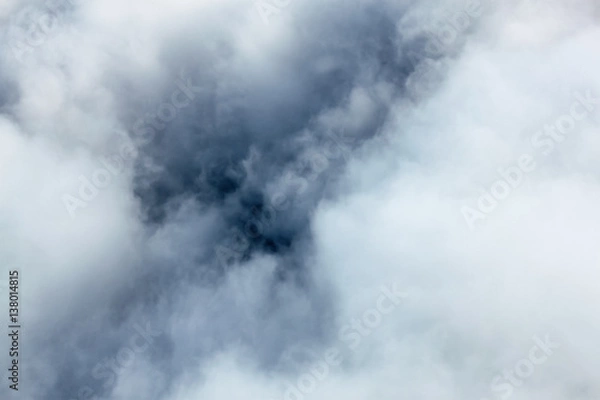 Fototapeta Inside a cloud, view on a cloud from an airplane, photo taken from above a cloud, looking towards a ground.