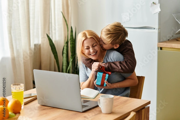 Fototapeta Mother and son share a joyful moment over a surprise gift in a cozy kitchen