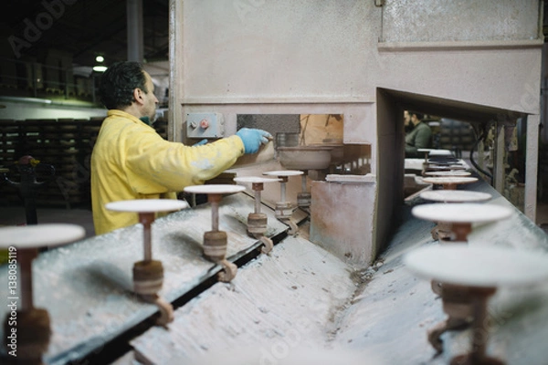 Fototapeta man that works in the factory of pottery