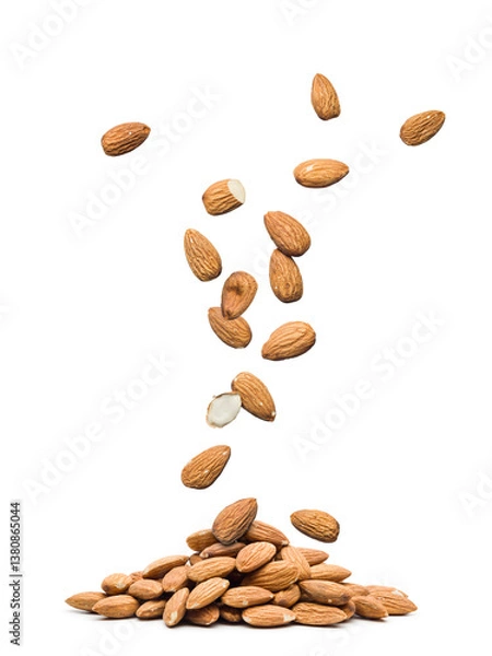 Obraz Almonds falling on a pile, isolated on white background.