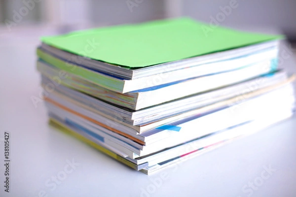 Fototapeta close up of stack of papers on white background