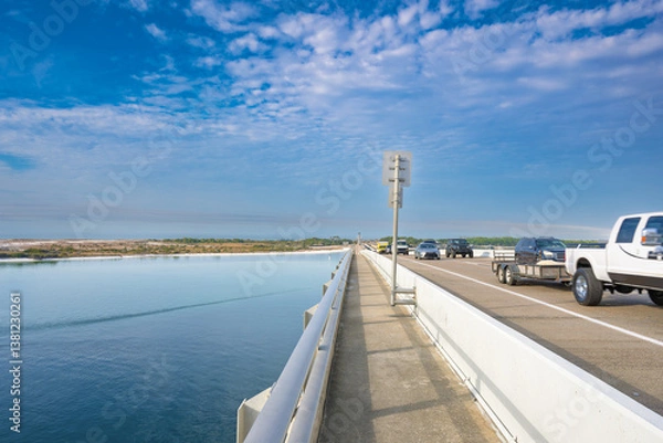 Fototapeta vehicle bridge with walking path at destin harbor