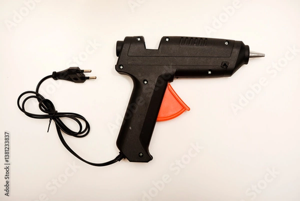 Obraz Black glue gun on a white background.