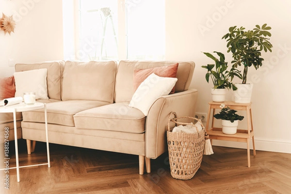 Fototapeta The bright and cozy interior of the living room with a sofa and various decor. Bright apartment with a window and furniture. Selective focus