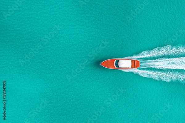 Fototapeta A stunning aerial view of a speed boat cutting through the turquoise ocean, leaving a white foamy