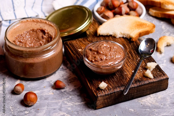Obraz Chocolate paste spread with hazelnuts and bread for breakfast
