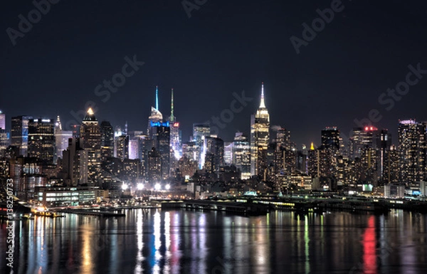 Obraz New York city skyline at night with building lights reflected in Hudson River