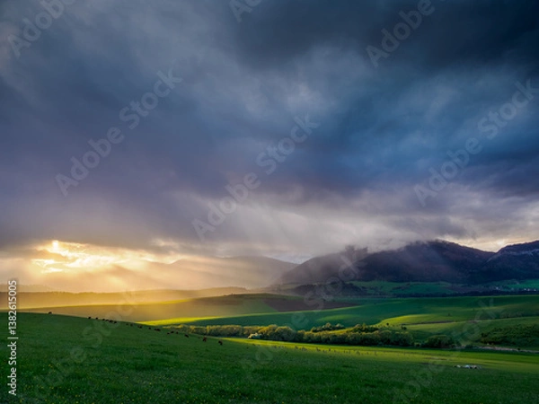 Obraz Mountain landscape. A view of the green hills with storm clouds looming over them. You can see the approaching rain from the clouds