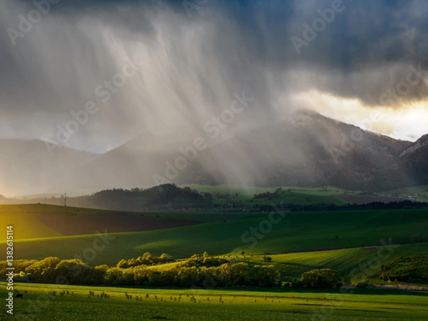Obraz Mountain landscape. A view of the green hills with storm clouds looming over them. You can see the approaching rain from the clouds