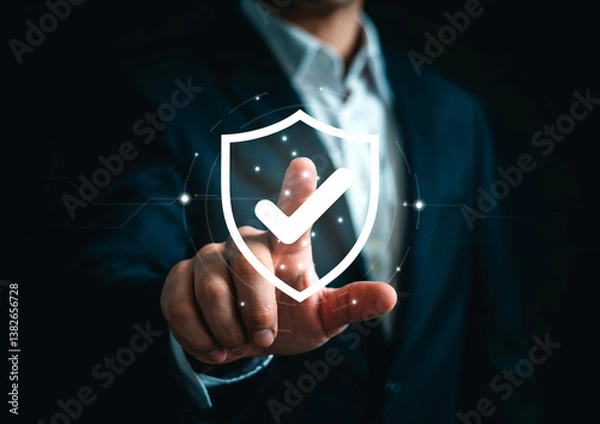Fototapeta Cybersecurity Concept - Shield with Checkmark Overlaid on Business Professional