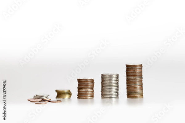 Fototapeta Stacks of coins arranged in ascending order, representing financial growth
